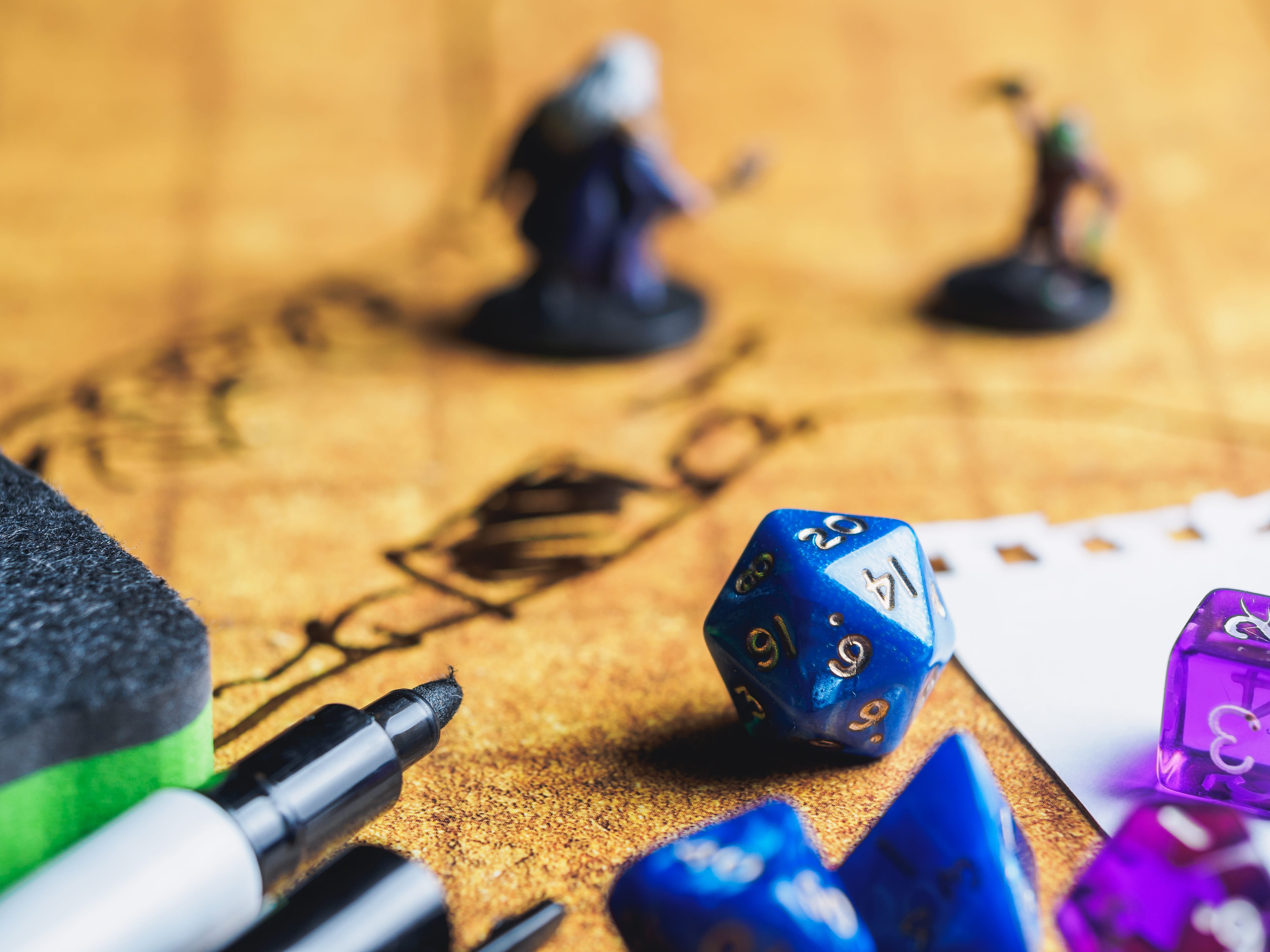 Several dice, markers, and minis on a map
