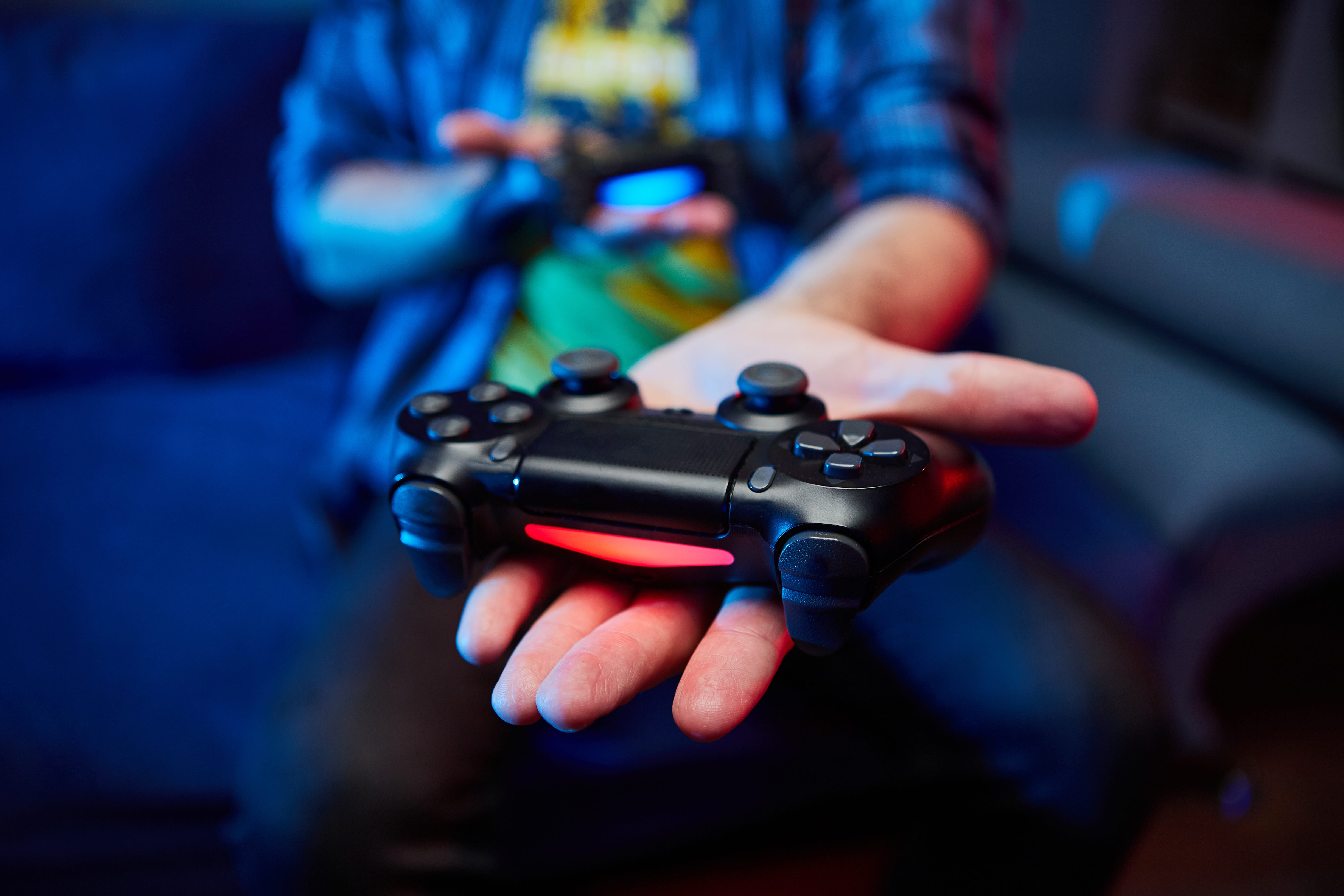 Person holding PS4 dualshock4 controller
